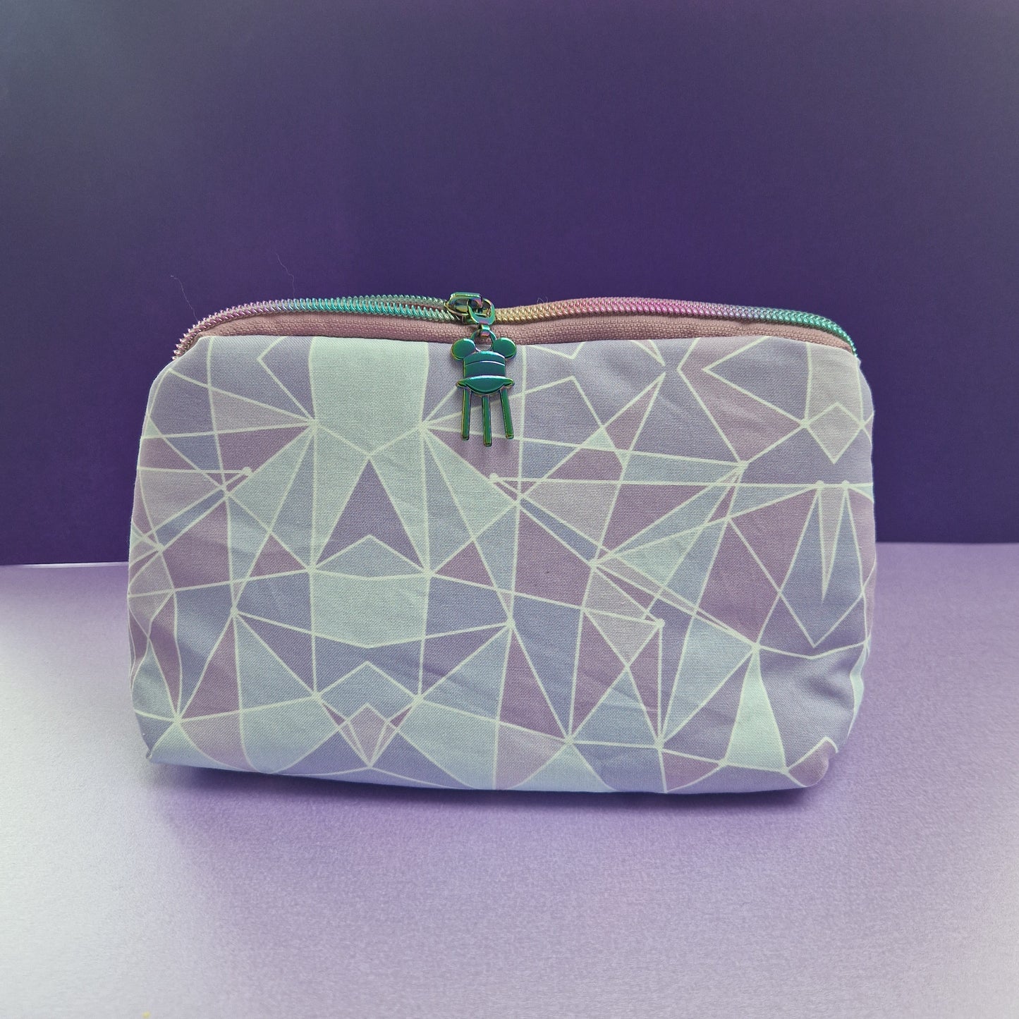 Purple Wall lined triangle cosmetic bag with water tower zipper pull
