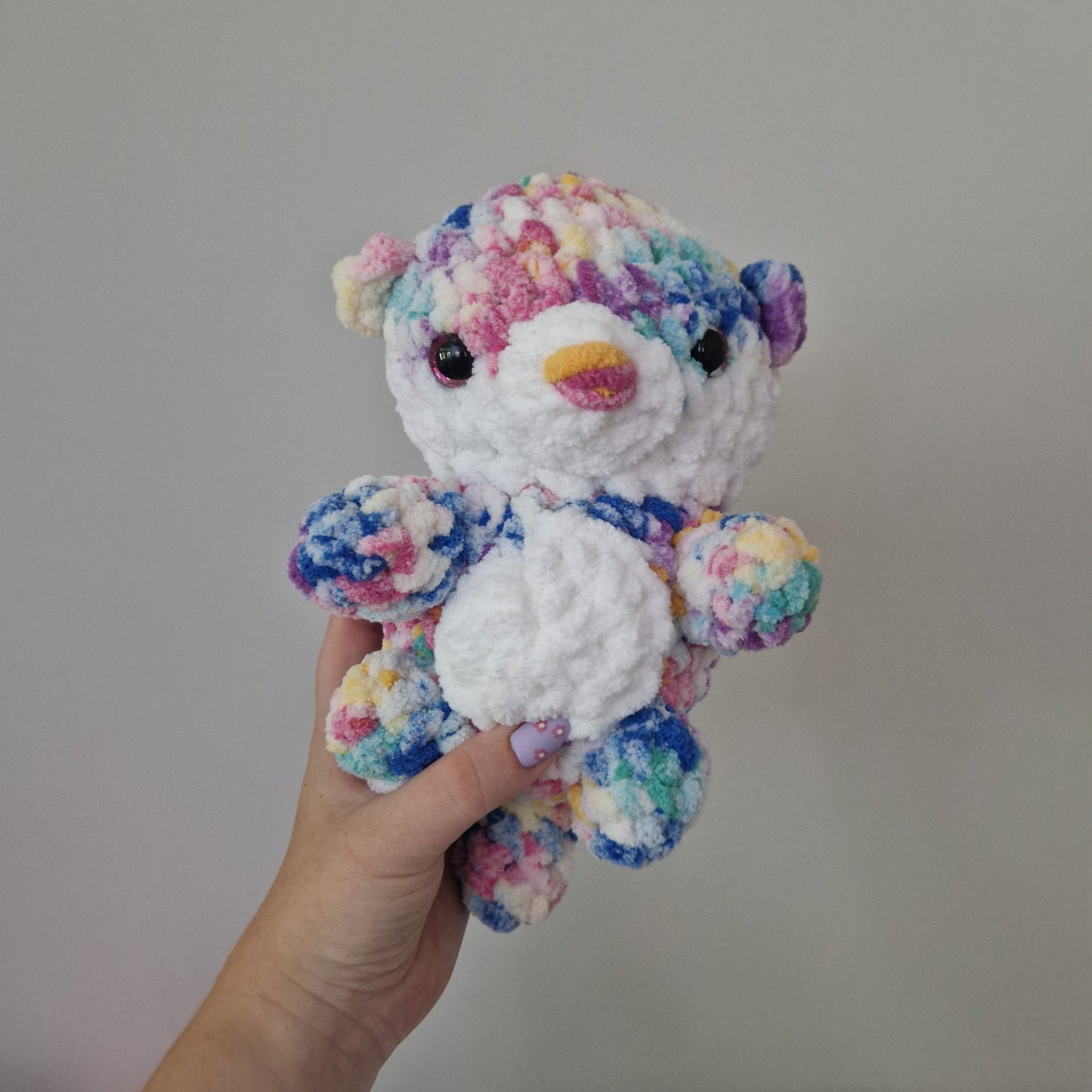 Bright rainbow otter crochet plushie
