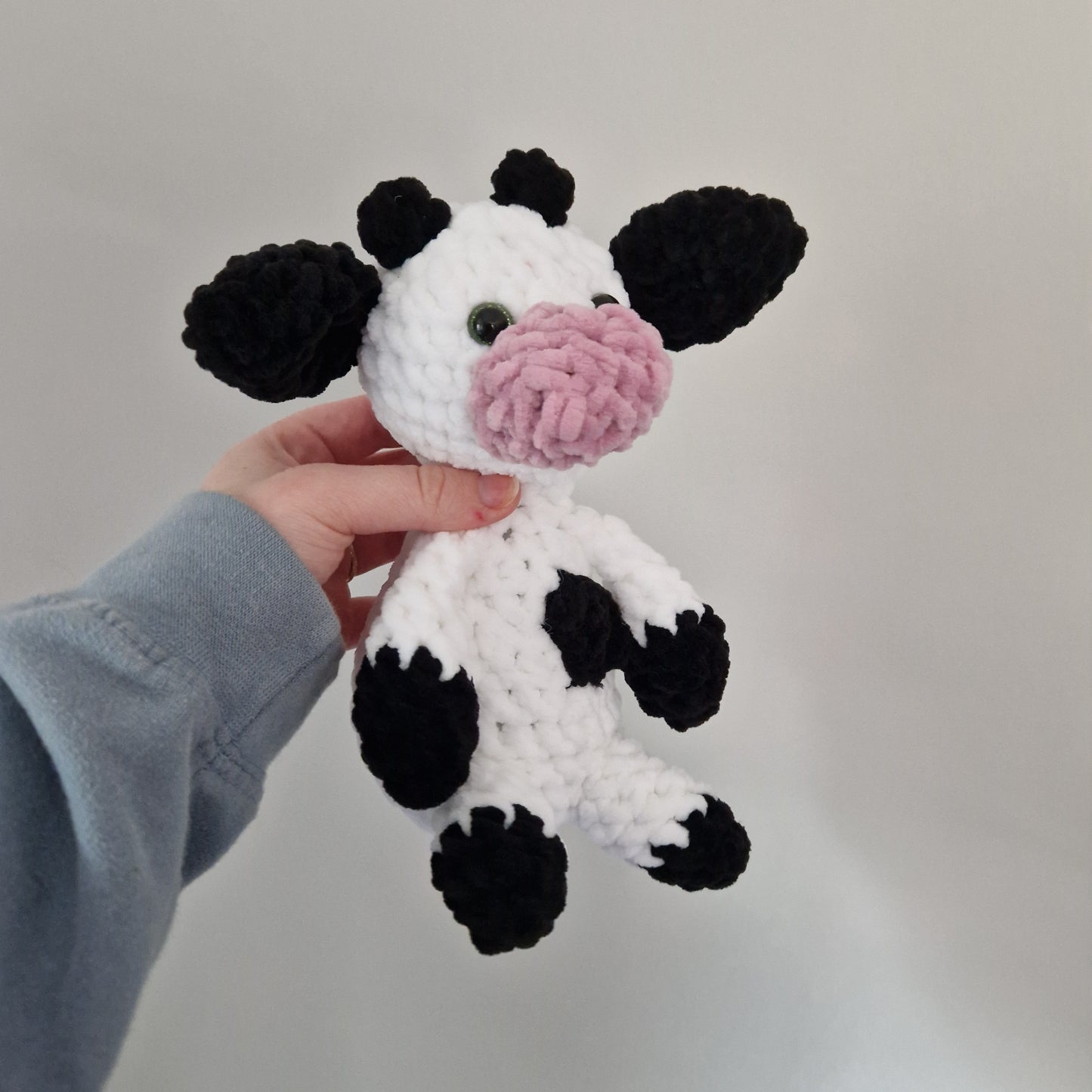 Black and white sitting cow crochet plushie