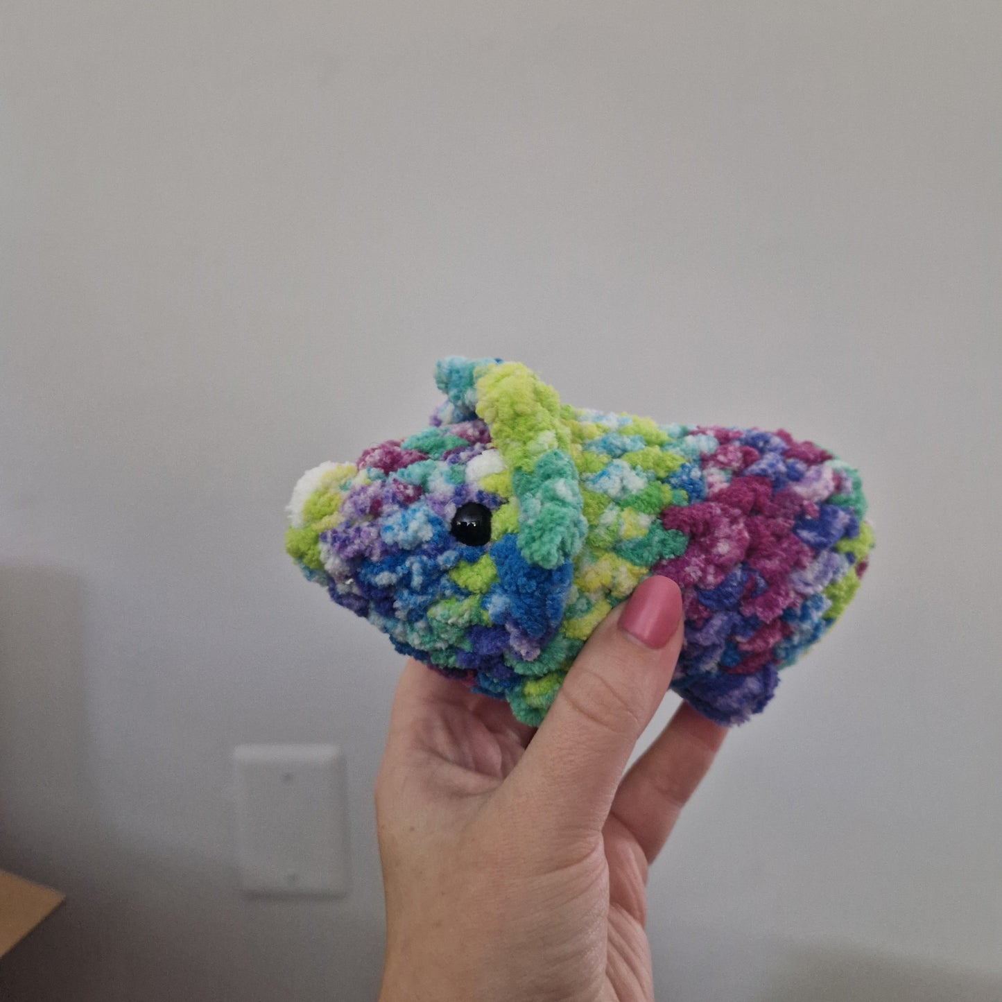 Green and pink triceratops crochet plushie