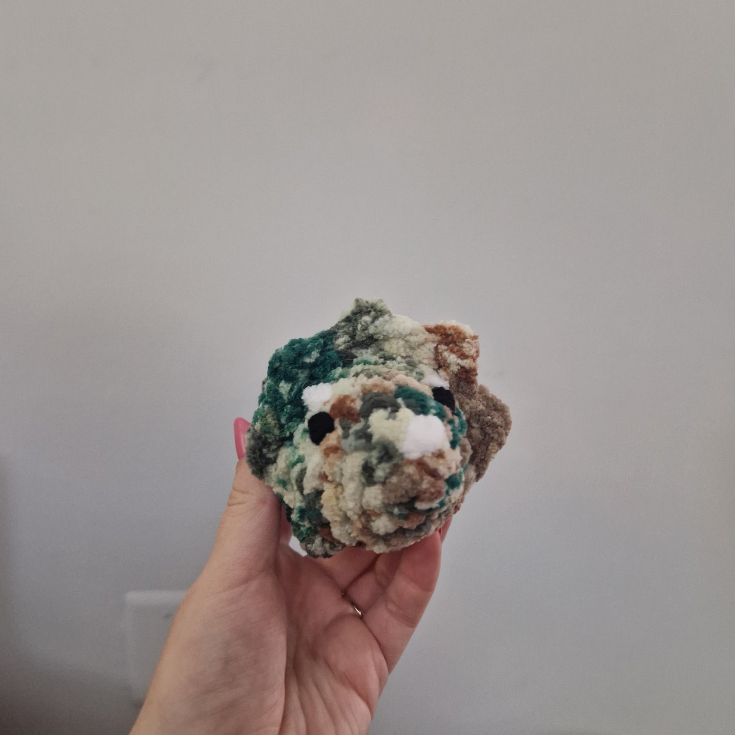 Brown and green triceratops crochet plushie