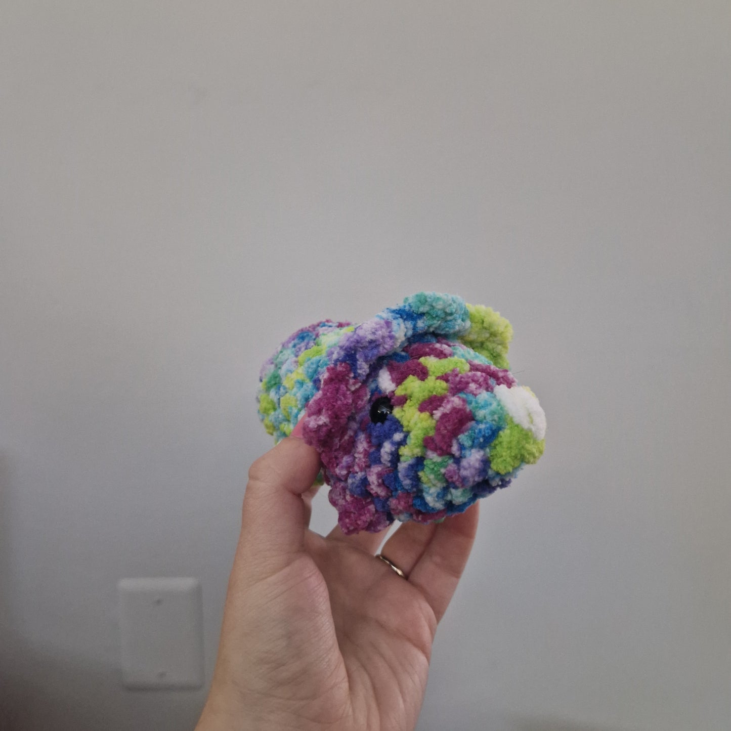 Green and pink triceratops crochet plushie
