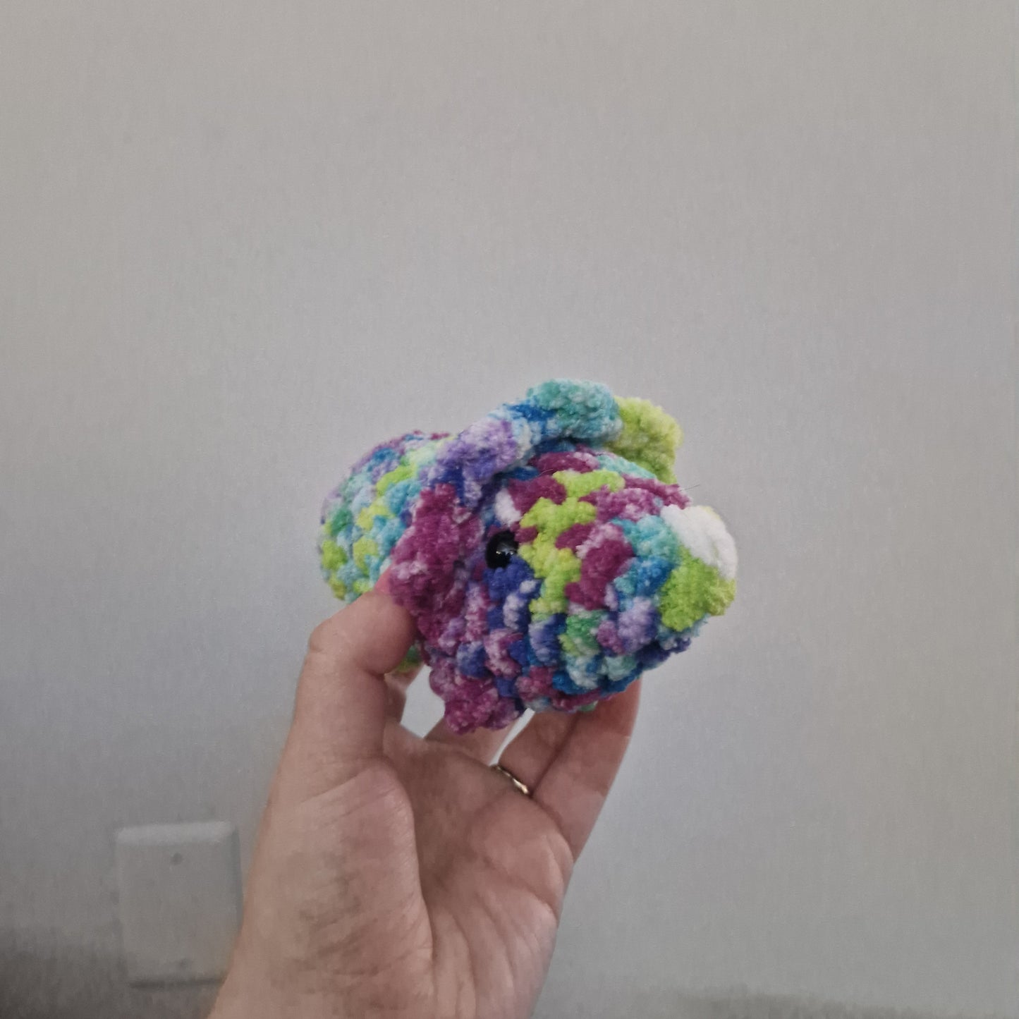 Green and pink triceratops crochet plushie