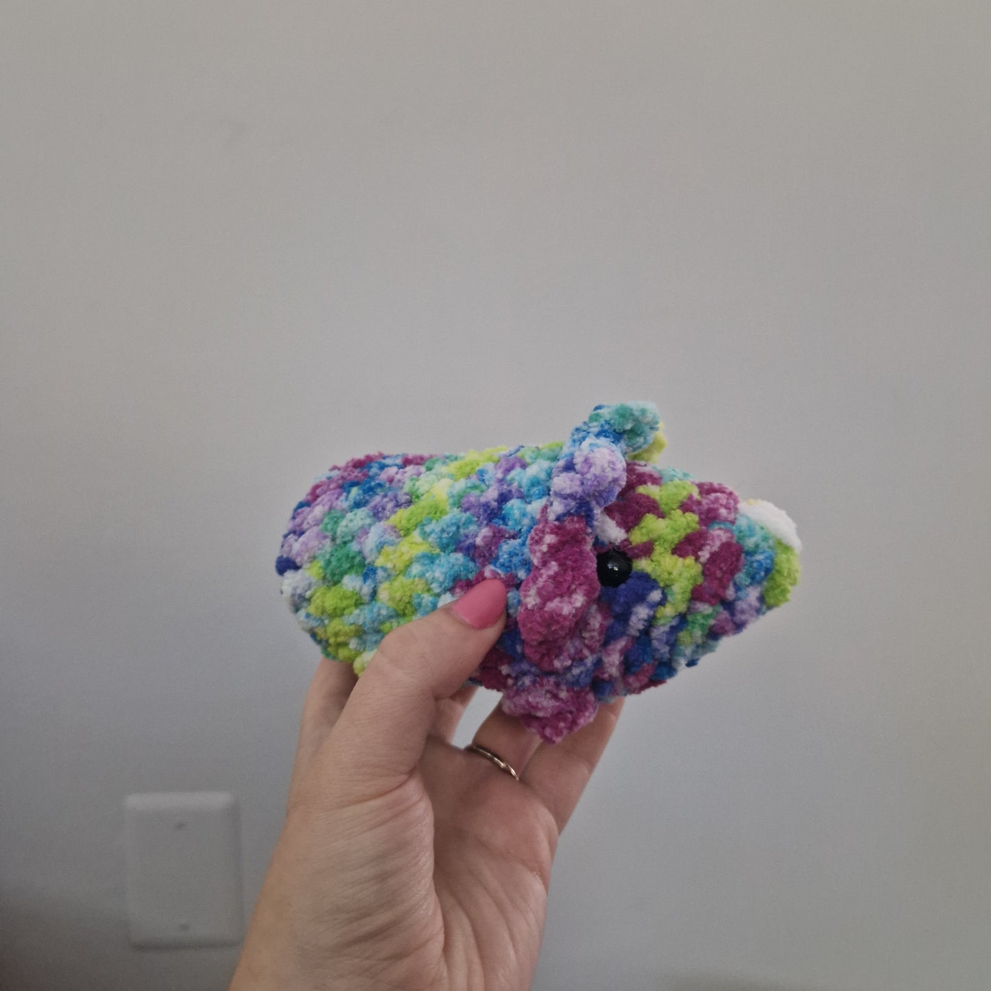 Green and pink triceratops crochet plushie